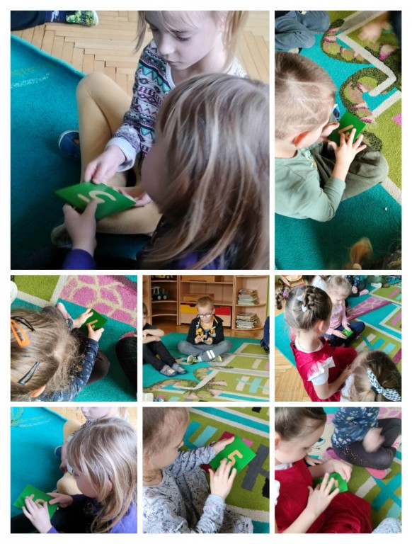dzieci wodza palcem po cyfrach na tabliczkach montessori