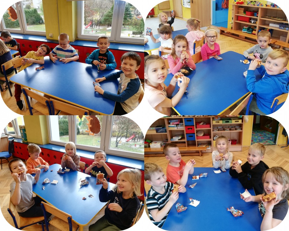 Dzieci siedza przy stolikach w przedszkolu