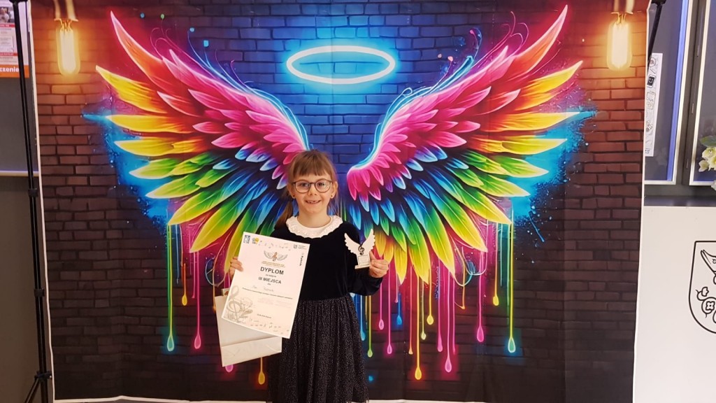 Dziecko z dyplomem i statuetką